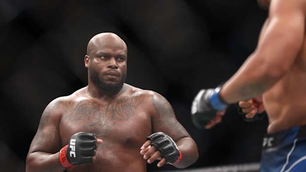 Derrick Lewis (red gloves) fights Ciryl Gane (blue gloves) during UFC 265 at Toyota Center.